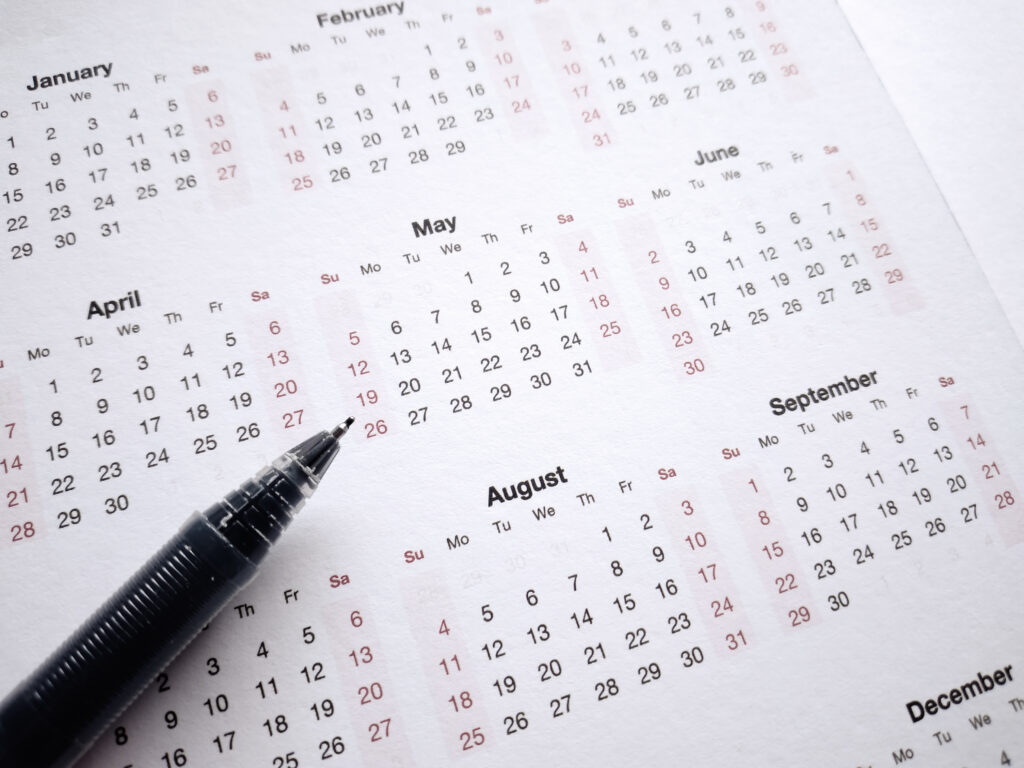 A calendar page with a pen planning | Can a Loan Build Credit?